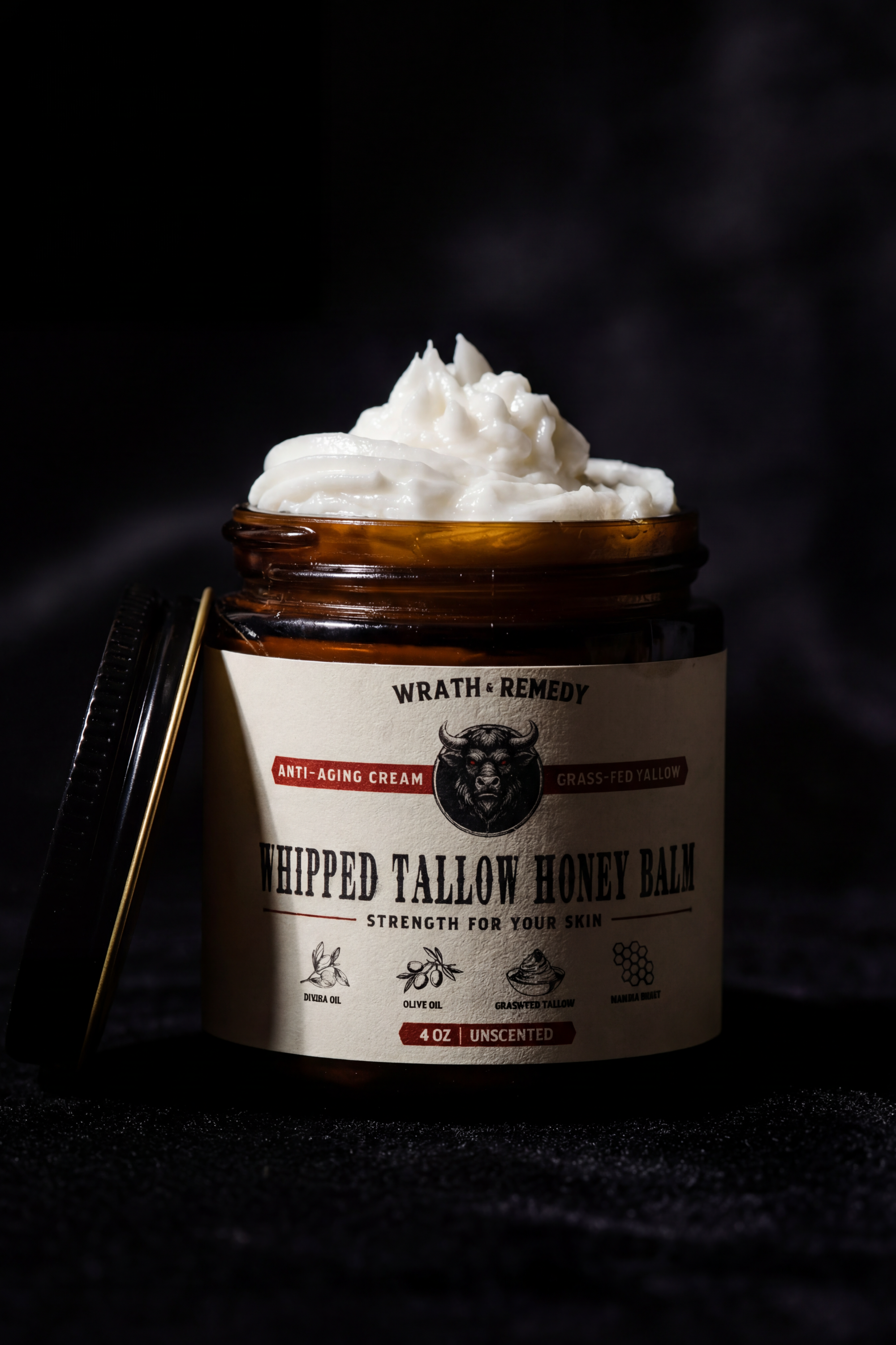 Jar of whipped tallow honey balm with visible brand name on a dark background