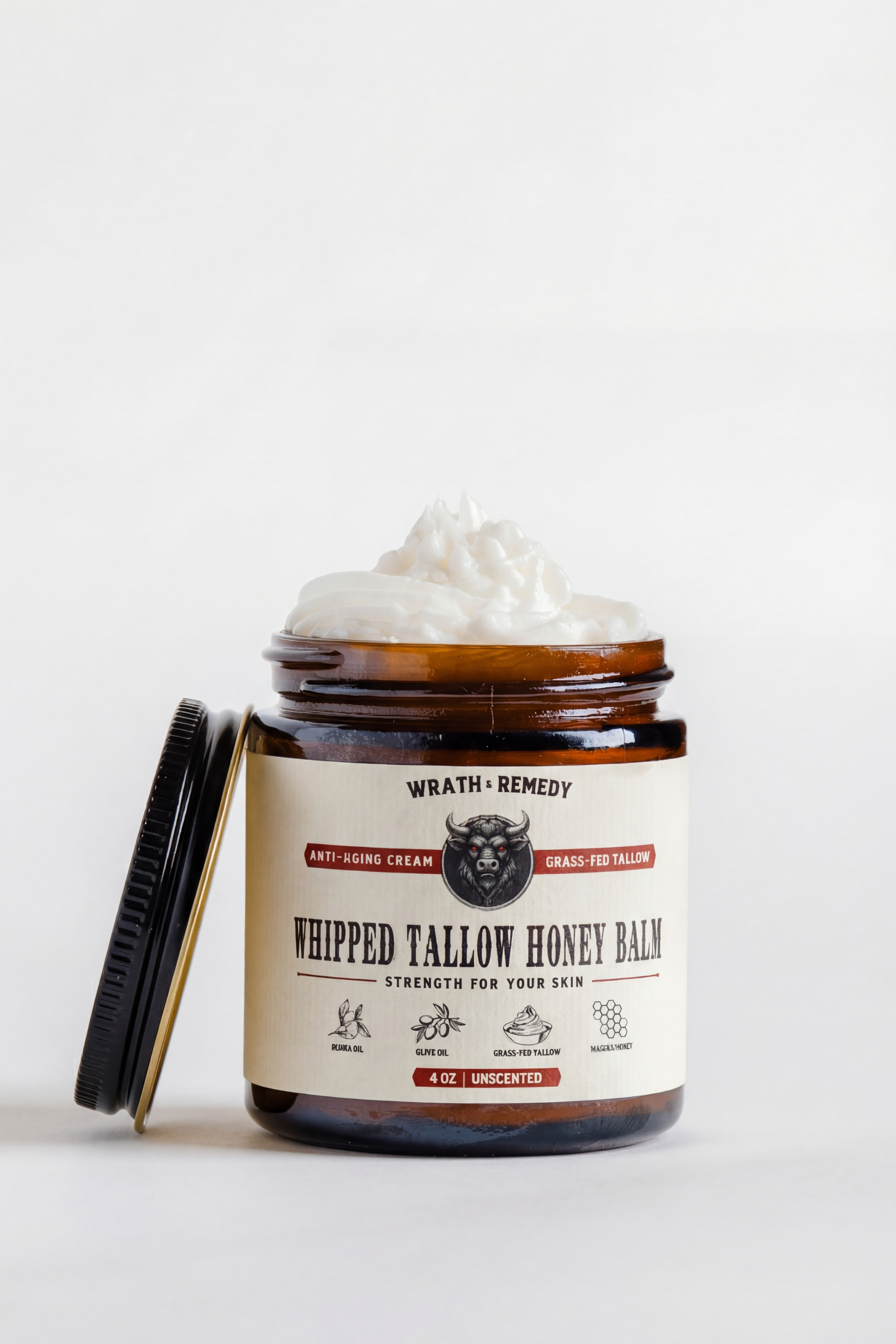 Jar of whipped tallow honey balm with a label on a white background