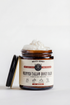 Jar of whipped tallow honey balm with a label on a white background